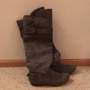 Over the knee tan boots with buckle detail.